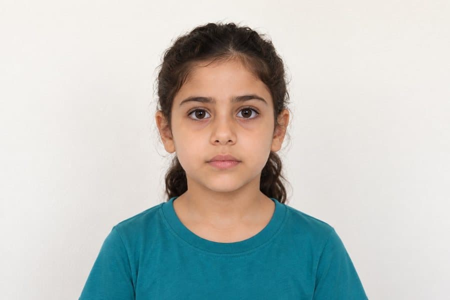 Facing the camera, mouth closed